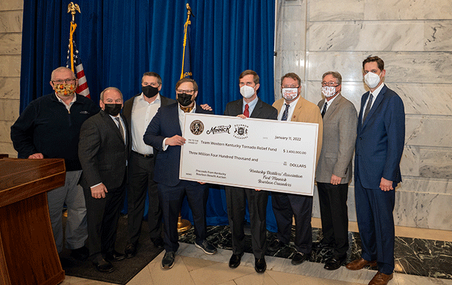 Members of the Bourbon community present a check to the governor of Kentucky