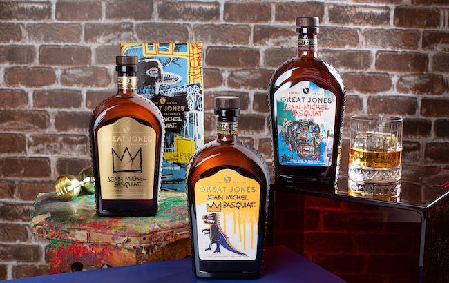 Three bottles of whiskey displayed with an artist's easel