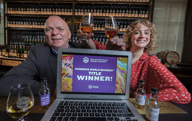 SMWS members John McCheyne, and Madeleine Schmoll setting a Guiness World Record for the biggest online whisky tasting