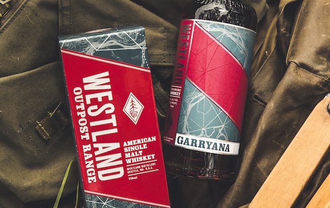 A bottle of whiskey on a canvas backpack