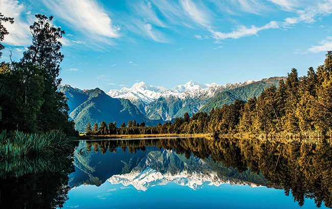 Reflections of Mount Cook and Mount Tasman in Lake Matheson, Fox Glacier New Zealand.