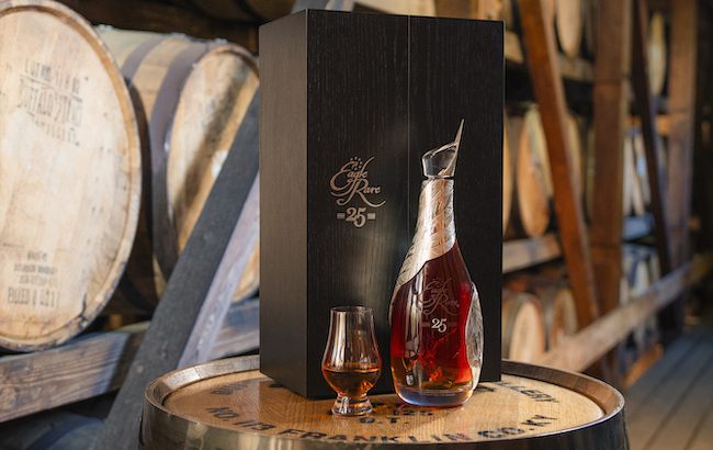 A luxury bottle of bourbon in a barrel warehouse