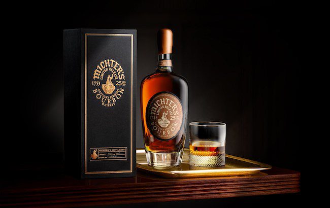 Bottle and glass of Michter's Bourbon on a dimly it tray