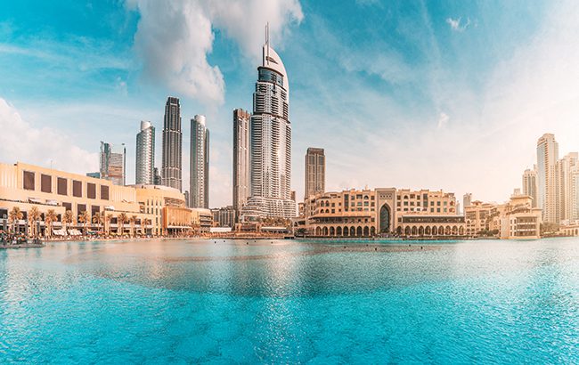 Water pond near the entrance to Dubai Mall and on promenade embankment with skyscrapers in the background