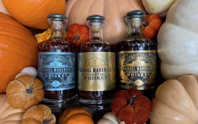 Three bottled of whiskies surrounded by pumpkins