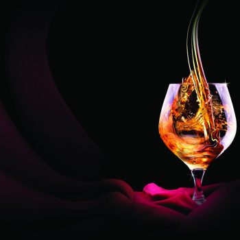 Cognac or brandy on a black background