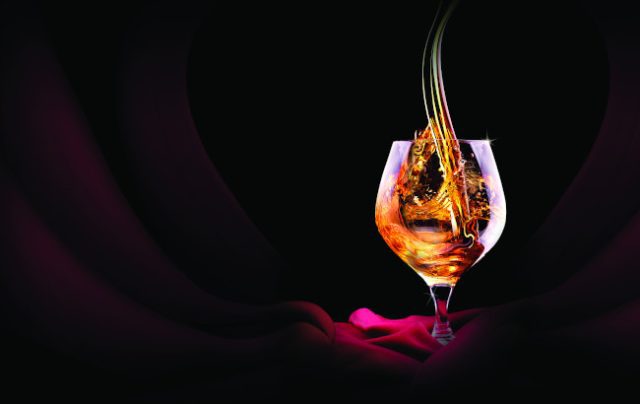 Cognac or brandy on a black background