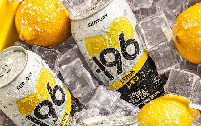 Cans of -196 lemon flavored vodka seltzer surrounded by ice and whole lemons