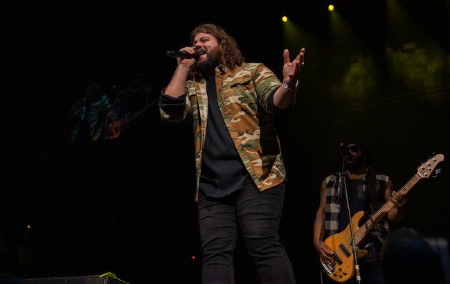 Country musician Dillon Carmichael performing on stage. Carmichael will amplify Four Branches Bourbon messaging while on the road this summer.