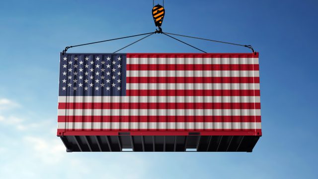 United States tariff trade cargo hanging against clouds background