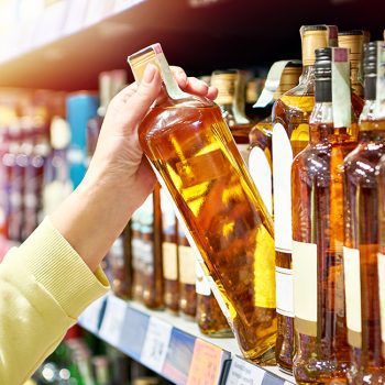 Bottle of whiskey in hand