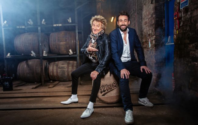Rod Stewart and Duncan Frew sitting on barrel