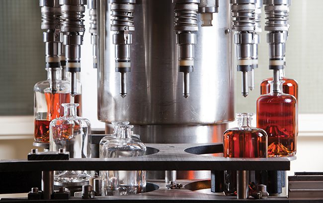 Bottle filling machine filling the bottles with liquor, third-party distillers