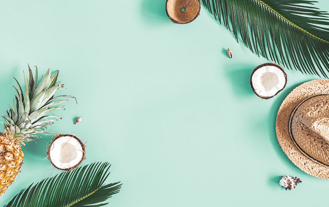 Summer composition. Tropical palm leaves, hat, fruits on mint background. Summer concept. Flat lay, top view, copy space